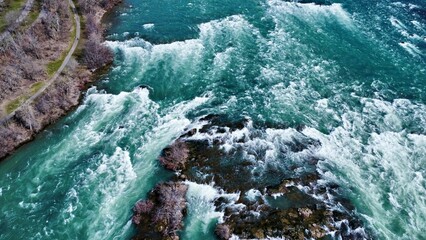 Sticker - Aerial view of sea waves against a rocky beach