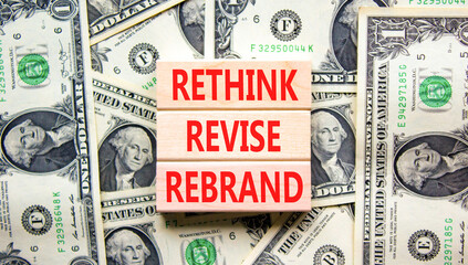 Rethink revise rebrand symbol. Concept word Rethink Revise Rebrand on block. Dollar bills. Beautiful dollar bills background. Business brand motivational rethink revise rebrand concept. Copy space.