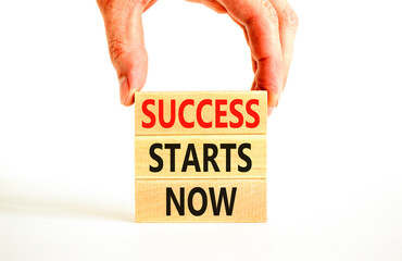 Wall Mural - Success starts now symbol. Concept word Success starts now on beautiful wooden block. Businessman hand. Beautiful white table background. Business motivational success starts now concept. Copy space.