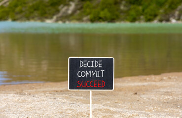 Wall Mural - Decide commit succeed symbol. Concept word Decide Commit Succeed on beautiful black chalk blackboard. Beautiful mountain lake sand beach background. Business decide commit succeed concept. Copy space.