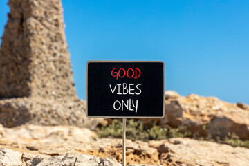 Wall Mural - Good vibes only symbol. Concept word Good vibes only on beautiful black chalk blackboard. Beautiful brown stone blue sky background. Business motivational good vibes only concept. Copy space.