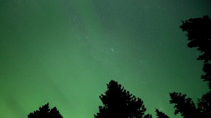 Wall Mural - time lapse of light to dark green clouds which are colored by aurora. the clouds are moving through 