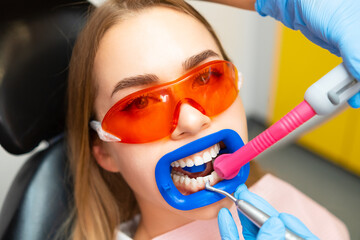 Wall Mural - Close up a patient while doing a professional teeth cleaning procedure at the clinic