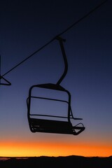 Sticker - Wooden chair situated on a lift overlooking a picturesque sunset