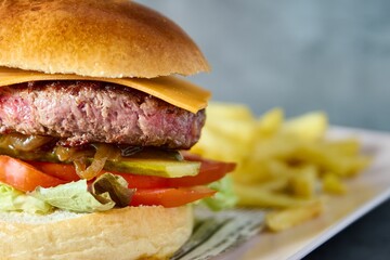 Sticker - a burger with french fries and tomato is pictured on a plate