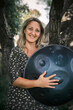 Portrait of a woman with a handpan her hands