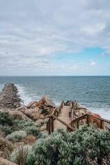 Poster - Set of wooden stairs descending from the cliff face. Victor Harbor, Australia.