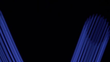 Wall Mural - blue neon strip glowing fast moving streams of light on black background