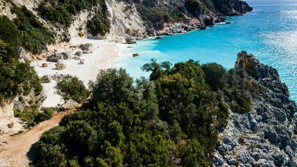 Poster - Picturesque Agiofili Beach featuring an expansive sandy beach, lush green trees, and a mountains