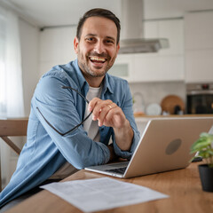 Wall Mural - one man adult caucasian work on laptop at home happy smile