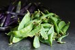 Fresh and healthy vegetables: Raw green sugar peas and purple beans  