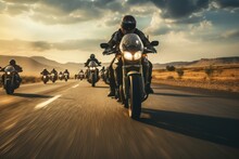 A Gathering Of Motorcyclists Riding Together. A Group Of Bikers Ride Fast Motorcycles On An Empty Road Against A Beautiful Cloudy Sky. Sport Bikes Are Fast, And Fun To Ride.