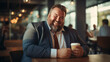 © EmmaStock - The businessman plus size holding coffee cup enjoy time in the office