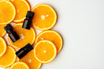 Wall Mural - Glass bottle of essential citrus oil on oranges background