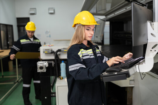 Technician caucasian woman use computer control print machine and team working background at office	