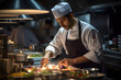 © JewJew - Male chef garnishing food under light at commercial kitchen.