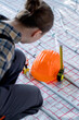 © volody10 - Worker near tools for repair hard hat, plier, glove on warm floor. Installation of a warm floor