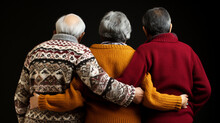 Rear View Of Three Older People, Two Old Men And In The Middle An Old Woman, Gray Hair, Winter Knitted Sweater, Best Friends Or Family