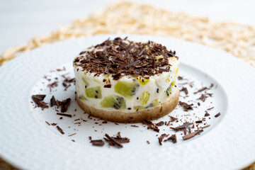 Wall Mural - Yogurt and kiwi cake with a cookie base decorated with grated chocolate.