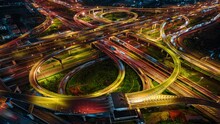 Aerial View Of Interchange And Motorway Road. Transportation Concept. Night Traffic Time Lapse. Hyperlapse. Bangkok, Thailand
