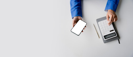 Wall Mural - portrait of woman working in finance using smartphone and calculator in modern office, preparing acc