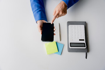 Wall Mural - Portrait of woman working in finance using smartphone and calculator in modern office, preparing accounting analysis report, real estate investment data, financial and tax concepts. and typing message