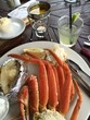seafood snow crab legs on a plate with a margarita drink