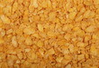 © dule964 - Crunchy corn flakes, cereal, muesli pile background and texture, top view