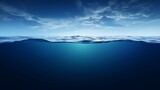 Split view horizon of blue sky with clouds and deep blue underwater ocean. Breathtaking Oceanic Panorama - with copy space to insert ads.