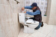 © Alvaro - Plumber repairing a toilet cistern