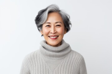 Canvas Print - Group portrait photography of a cheerful Vietnamese woman in her 50s wearing a cozy sweater against a white background