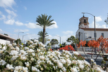 Wall Mural - South Gate, California, USA - February 11, 2023:  Sun shines on a historic church and street scene in South Gate.