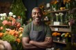 © Stavros - Smiling African American man standing in his flower shop. Middle aged salesman is waiting for customers of the flower shop. He standing at the entrance and smiley looking at camera. Format photo 3:2.