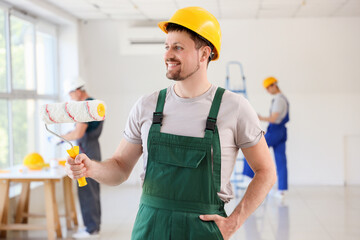 Sticker - Male builder with paint roller in room