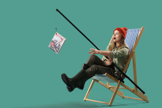 Surprised young woman with fishing rod and magazine on green background