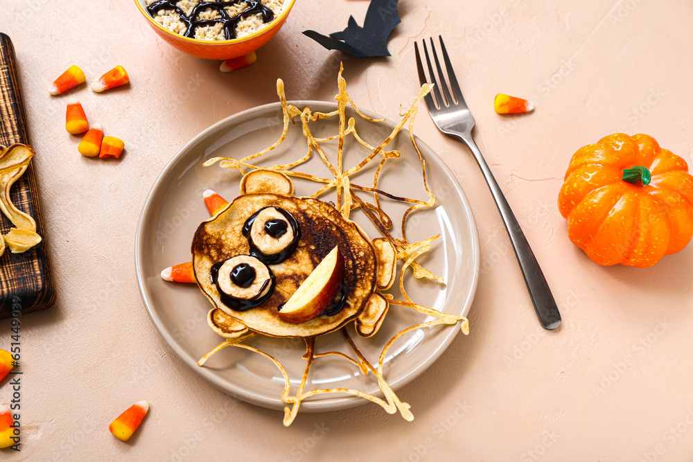 Composition with funny Halloween breakfast and decorations on color background