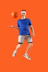 Sticker - Jumping male basketball player on orange background