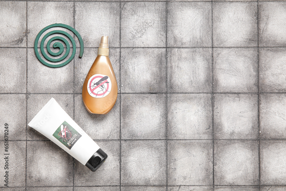 Different mosquito repellents on grey tile background