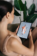 A female fitness trainer dressed in a stylish competitive suit runs her online blog on a tablet. Checklist, review and planning with female trainer on online workouts, tasks and digital analysis