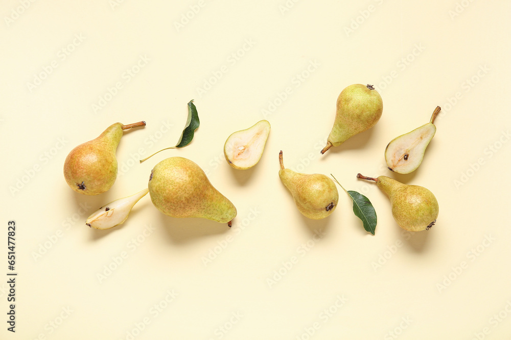 Ripe pears and leaves on yellow background