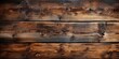 The textured background of old, dark brown wooden planks, reminiscent of the weathered walls found in an antique barn.