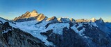 Fototapeta Mapy - High tour to the Wetterhorn. First rays of sunshine on the Schreckhorn in the Bernese Oberland. Sunrise in a breathtaking mountain landscape. Large glaciers above Grindelwald Interlaken Switzerland