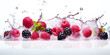 A dynamic and colorful still life of mixed berries in a splash of water.