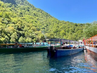 Colorful boats at turquoise blue Shala river, Albania.