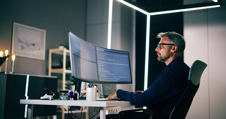 Coder Using Computer At Desk