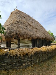 Wall Mural - A hut with straws in front of it