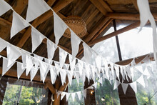 Garlands Of White Flags In A Wooden Gazebo.. Summer Wedding Garden Party.