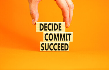 Wall Mural - Decide commit succeed symbol. Concept word Decide Commit Succeed on beautiful wooden block. Businessman hand. Beautiful orange table background. Business decide commit succeed concept. Copy space.