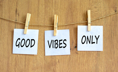 Wall Mural - Good vibes only symbol. Concept word Good vibes only on beautiful white paper on wooden clothespin. Beautiful wooden table wooden background. Business motivational good vibes only concept. Copy space.