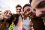 Fototapeta  - Crazy selfie of a group of young multirracial people embracing. Exited friends enjoying leisure and laughing a lot looking at camera outdoors. Diverse guys and girls community celebrating together